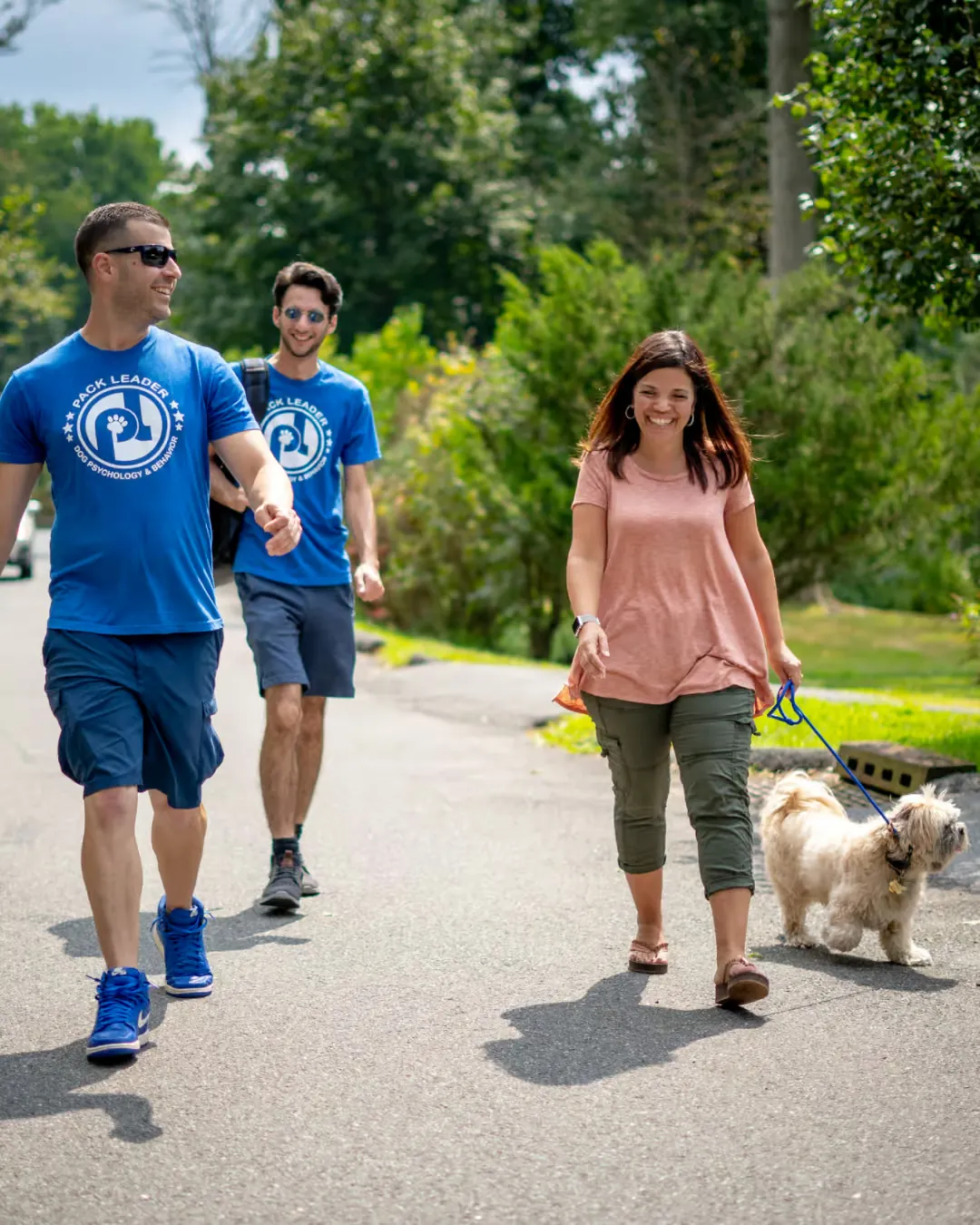 A dog walking attentively on a loose leash during a training session.
